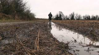 Wearing Black rubber boots in a muddy field