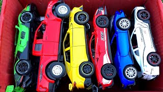 Box Full of Diecast Cars /Lamborghini SCV12, Ferrari 488, GTR R35, Ford Raptor, Mercedes SLR, Audi