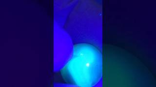 Uranium Glass marble fluorescing after digging up from dump