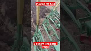 plowing with a 8 bottom John Deere plow behind a case steam engine