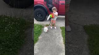 Girl is determined to bring in the groceries in just one trip!