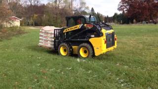 New Holland L218 carrying pallet of salt