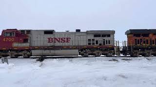 Two BNSF grain trains meet with foreign power and a warbonnet