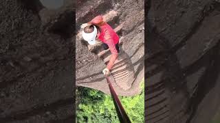 Rock climbers demonstrate climbing and descending stone stairs on a cliff