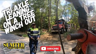 Tri-axle Leaning On A Tree Winch Out