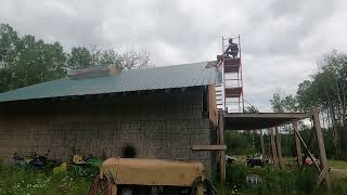 Installing The Last Two Pieces Of Roofing Metal On This Side Of Our Post And Beam Building.