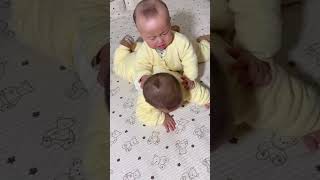 Baby twins ride on top of each other and cry