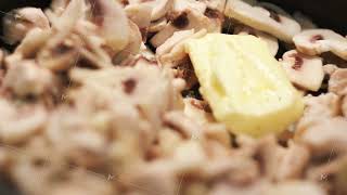 Fried chicken meat, mushrooms and butter in a frying pan. Concept. Close up of preparing chicken