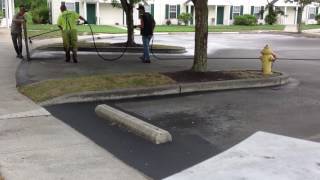 SPRAYING A WATER BASED SEALER ON A ASPHALT PARKING