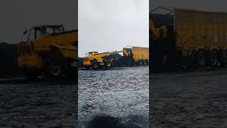 JCB Telehandler unloading coal in the rain