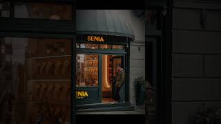 A Man Standing in front of a Shop in a rainy day