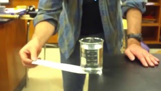 table cloth trick with beaker of water