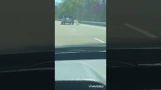 man drives bye cop with tailgate hanging off!