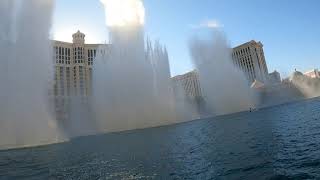 Imagine Dragons Sharks video in Bellagio Fountain. Red coat surfer. Compare the videos