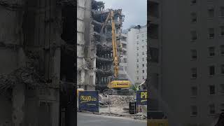 Massive demolition of tall buildings using large cranes