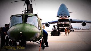 U.S. C-5 Super Galaxy Crew Loading the Helicopters and Trucks