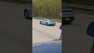 Baby Blue Porsche Taycan driving slow