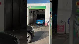 Blue Ford Mustang getting a carwash