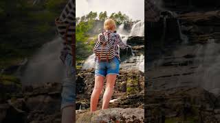 Girl standing in front of waterfall #girl #standing #waterfall #relaxing #travel #youtubeshorts