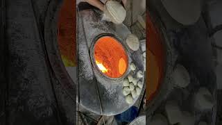 Making roti/naan/bread in traditional Indian tandoor