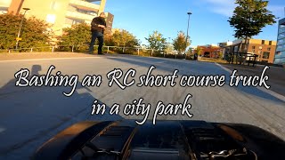 Bashing an RC short course truck in a city park (hood camera view)