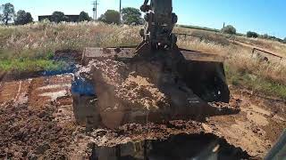 Volvo excavator working on deepening COTTON field drainage