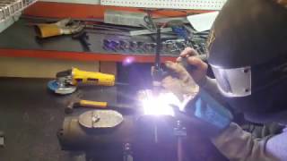 Girl welding ScalerFab land Anchor in metal shop- TIG Fusing