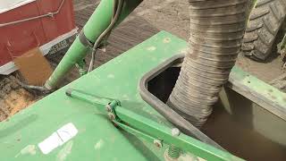 Filling John Deere 777 air cart with wheat seed