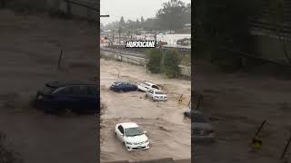 Hurricane Milton washes cars down street