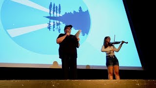 Michael Moore kicks off 15th Traverse City Film Festival by passing the hat for violinist