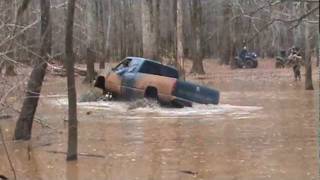 Huge mud trucks in deep slough