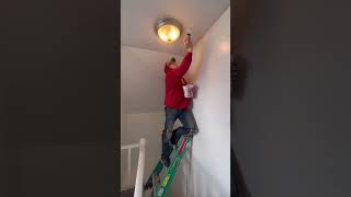 Painting over a stairway on a ladder #daily #construction