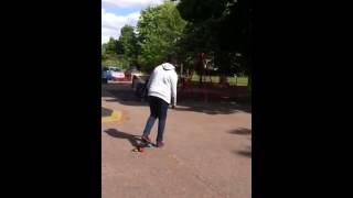 Abdi trying to ride a skateboard