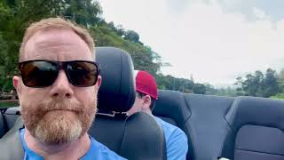 Happy Parents Driving In A Convertible In Hawaii