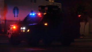 SWAT Bearcat and Police Cars Responding Code 3 to a Barricaded Suspect in Sacramento CA