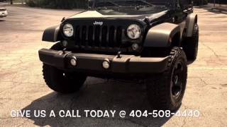 2016 Jeep Wrangler sitting on 18" Mickey Thompson 245 wheels leaving RimTyme Stone Mountain