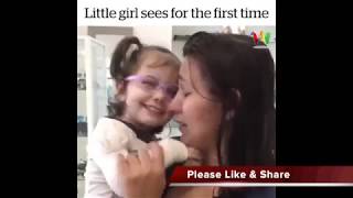 Little girl sees the world for the first time with her mother after surgery.