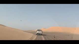 Journey from Mr. Ghalit's mine to Mine15 on a desert highway surrounded by sand dunes in Mauritania.