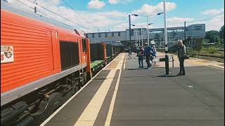 DB Schenker liveried 66175 Rail Riders heading through Peterborough Station platform 4.