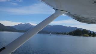 Cessna 206 taking off from Lake Te Anau