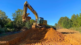 Cutting in a road with a CAT 320 and CAT 953K