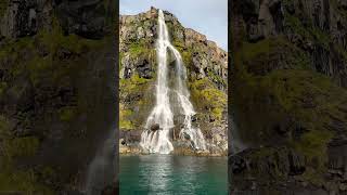 Beautiful waterfall drop down straight into the ocean, Iceland