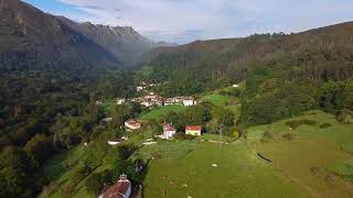 Elevated Serenity: Drone's Eye View of Houses Nestled Among Mountains