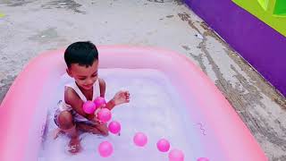 Tanbir is playing in the swimming pool with coloring ball and learn colors.