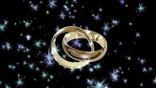 Two wedding rings beautiful bright stars on the background