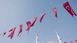 Turkey, Istanbul-December, 2020: Turkish flags on blue sky background. Action. Festive ribbon with