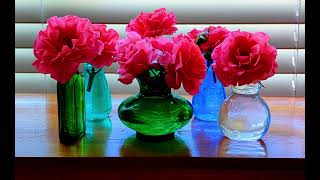 Roses in Different Glass Bottles