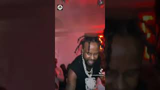 popcaan chilling at a party