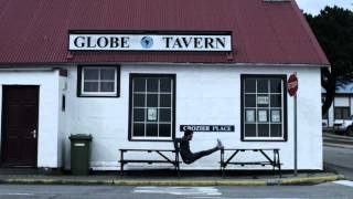 Argentinian hockey player Fernando Zylberberg exercises on a British war memorial in the Falklands