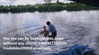 Out of church Christian baptized into Jesus in the river Ouse in St. Ives, Cambridgeshire UK